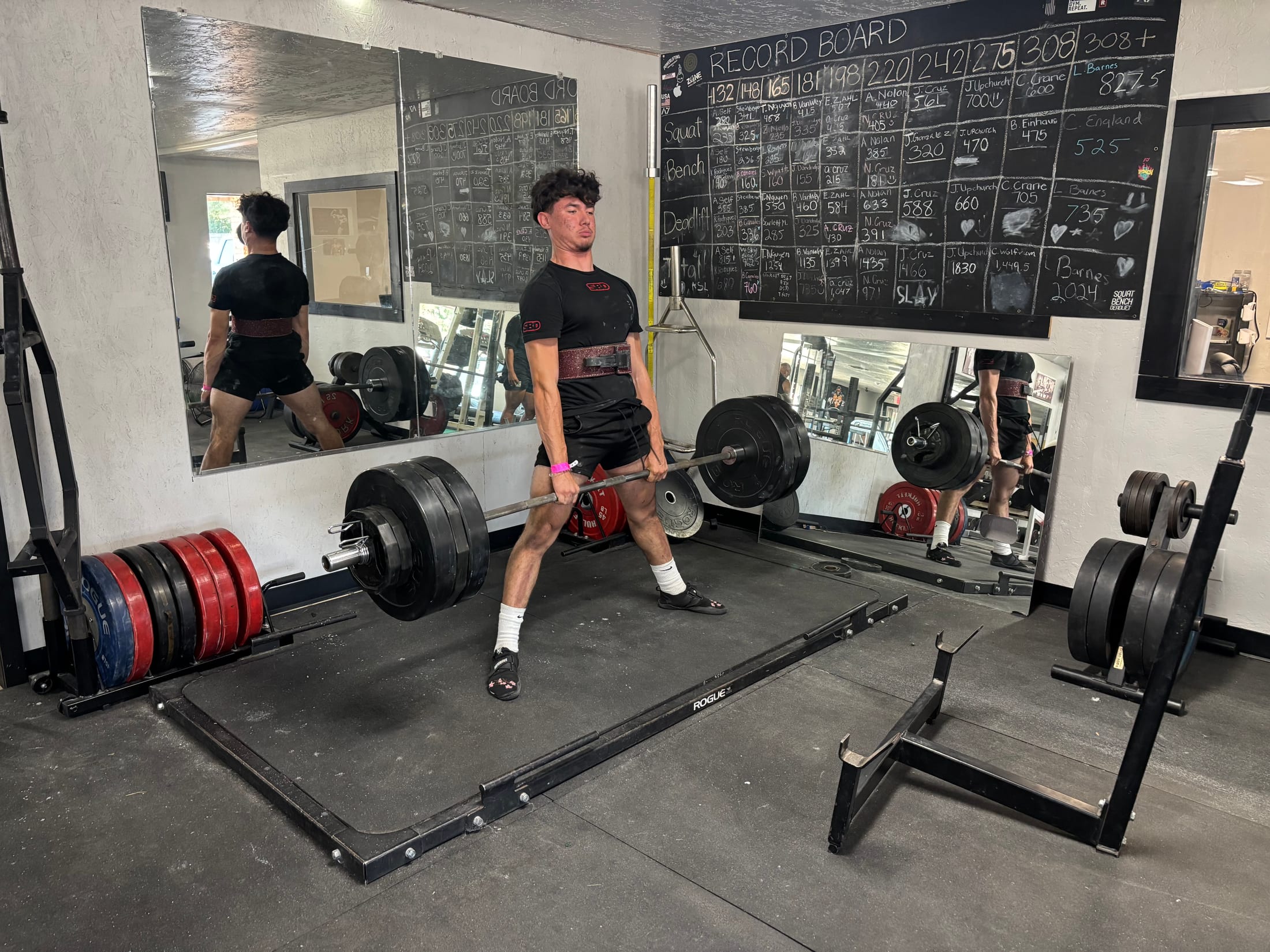 A member completing a heavy deadlift
