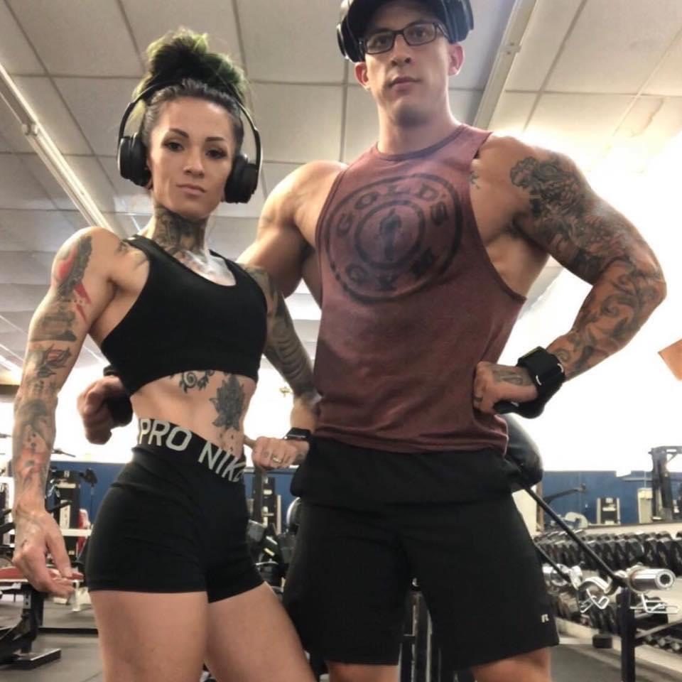 Two members posing together on the gym floor