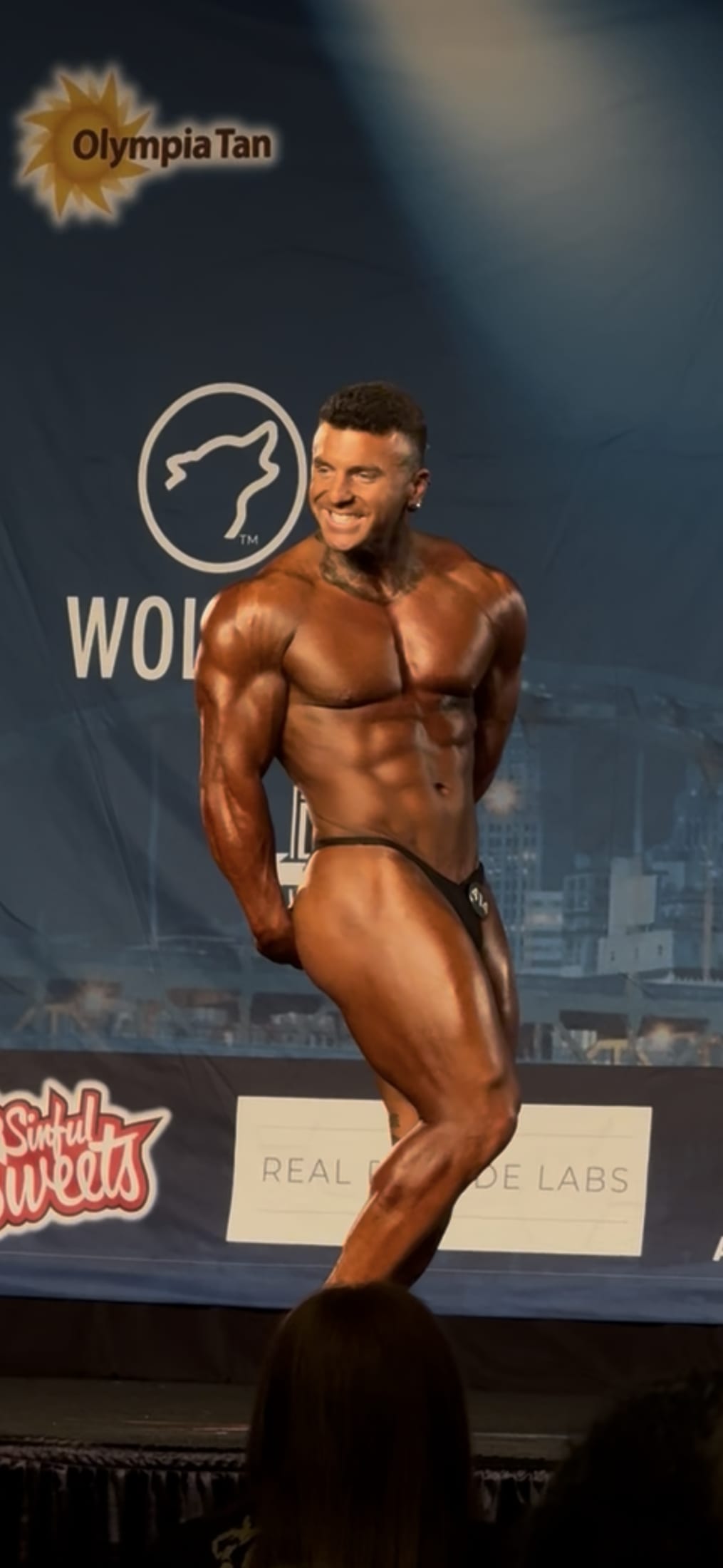 Lance Dooley posing on a bodybuilding stage