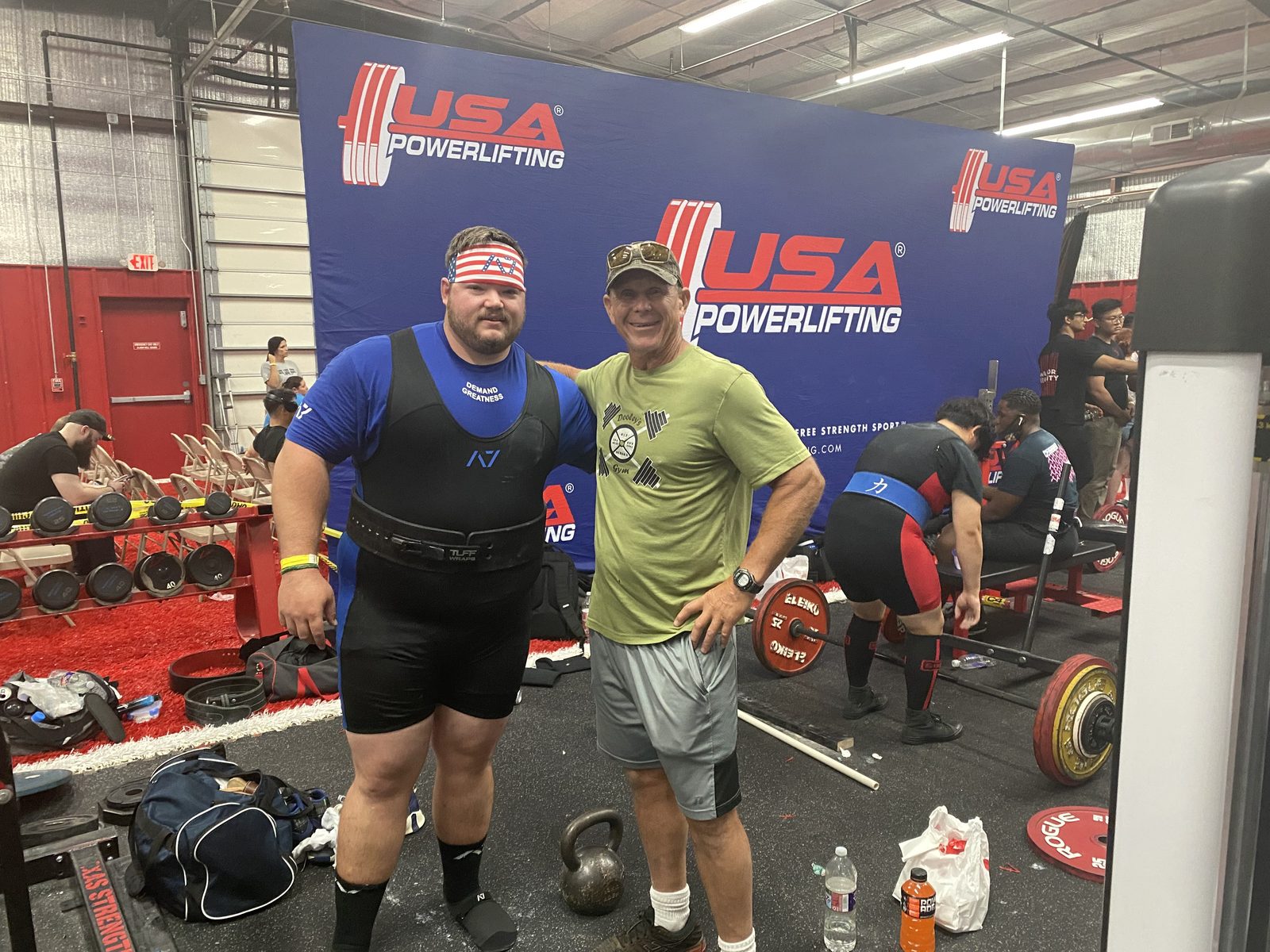 Jim Dooley with a powerlifting competitor at a meet