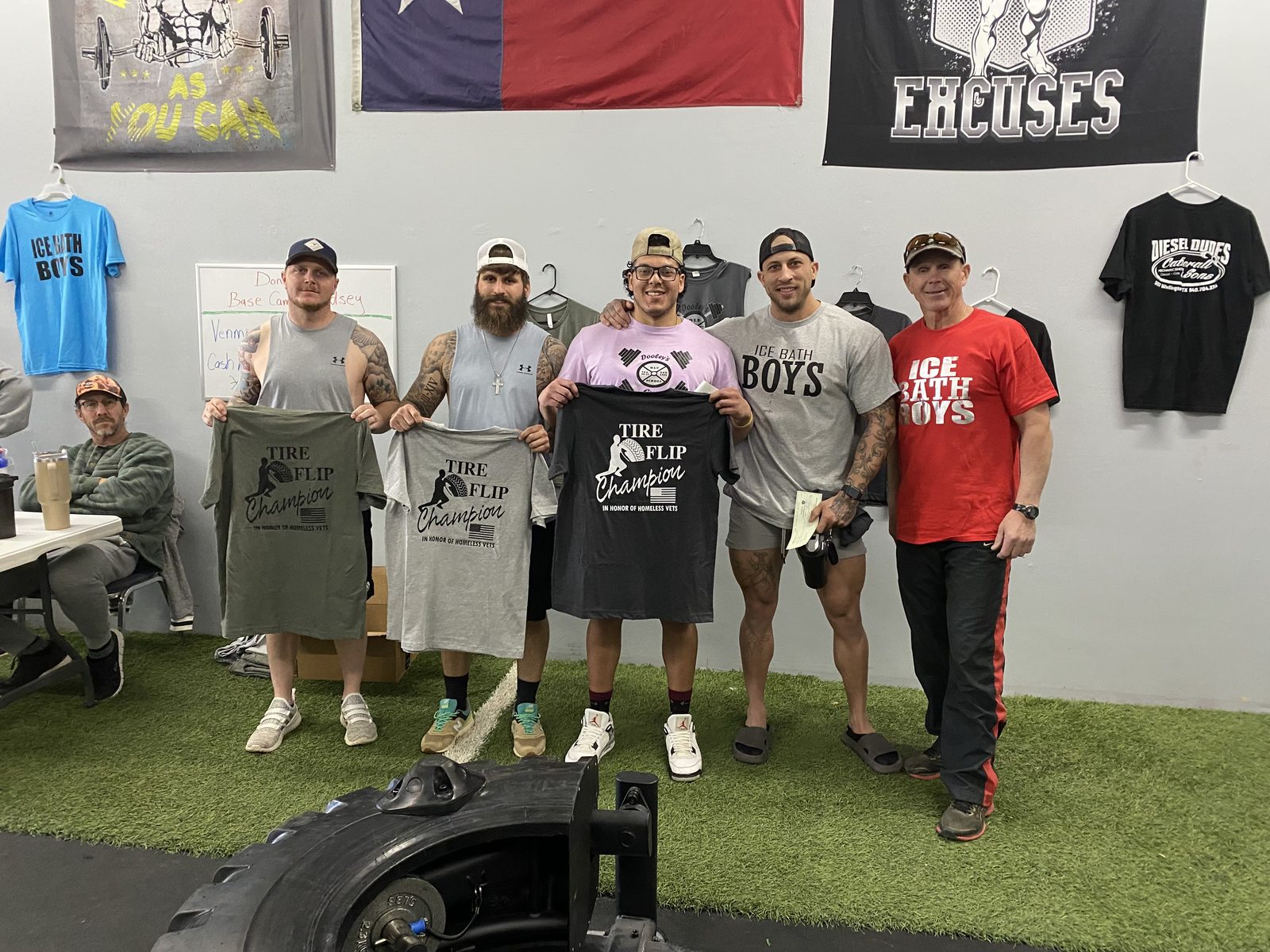 Members celebrating a tire-flip competition together